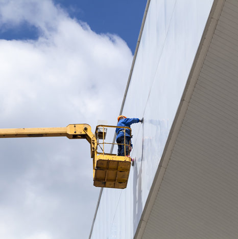 cleaning skyscrapers outside with a crane - window washing