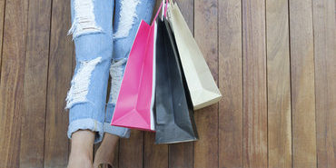 Closeup of woman holding shopping bags  with copy space Closeup of woman holding shopping bags with copy space