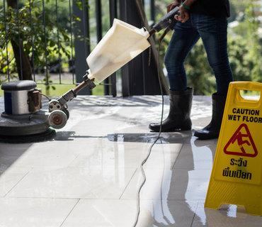 The people cleaning floor with machine. commercial clean floor